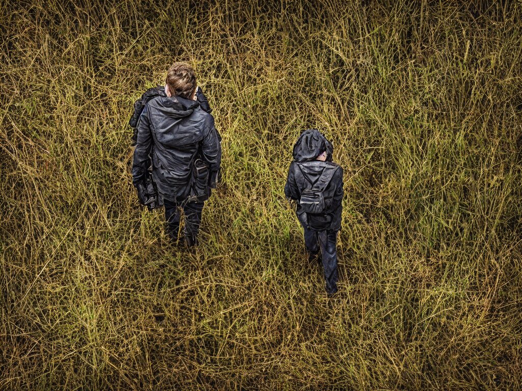 A mom and son walking on a road and growing